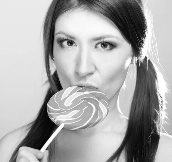 Girl sucks big candy — Stock Photo, Image