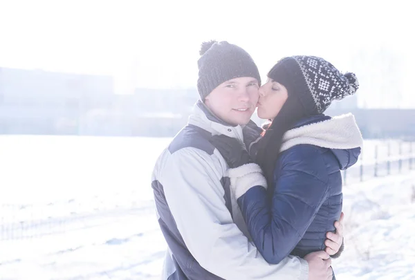 Young couple kissing on nature in winter — Stock Photo, Image