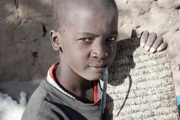 Boy and his manuscript in Arabic