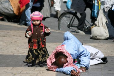 Tramp and child in the old city of Sanaa (Yemen). clipart