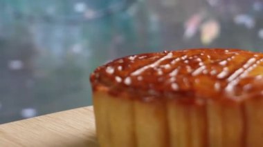 Mooncake being served on wood platter board. Traditional Mid-autumn Festival celebration Chinese food. 