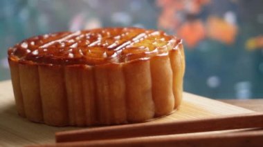Mooncake being served on wood platter board. Traditional Mid-autumn Festival celebration Chinese food. 