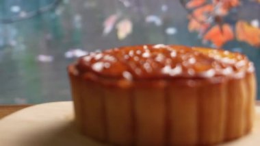 Mooncake being served on wood platter board. Traditional Mid-autumn Festival celebration Chinese food. 