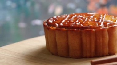 Mooncake being served on wood platter board. Traditional Mid-autumn Festival celebration Chinese food. 