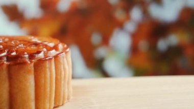 Mooncake being served on wood platter board. Traditional Mid-autumn Festival celebration Chinese food. 