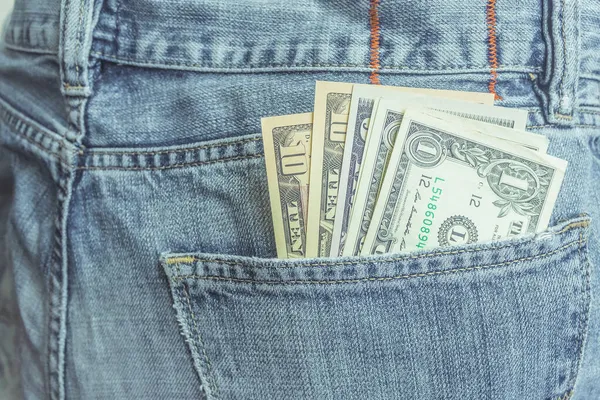 斜纹棉布牛仔裤后兜里的美元 — 图库照片