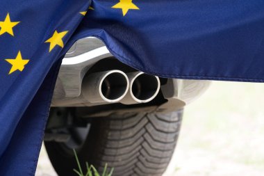 A car, exhaust pipe and European Union flag