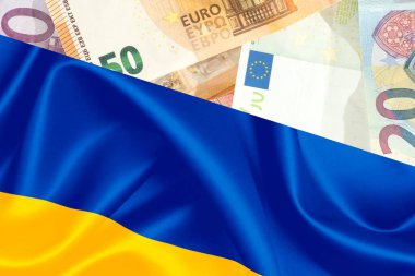 Flag of Ukraine and Euro banknotes