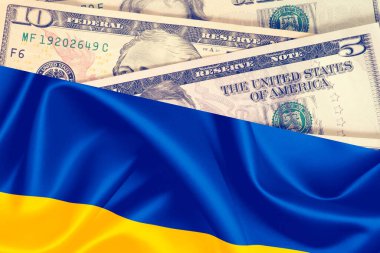 Dollar banknotes and flag of Ukraine