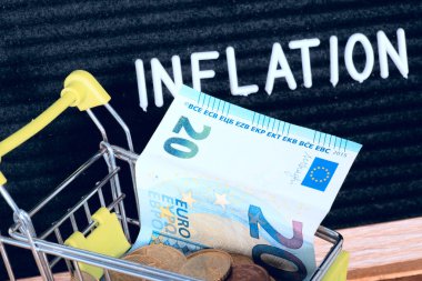 Shopping cart, euro banknotes and inflation