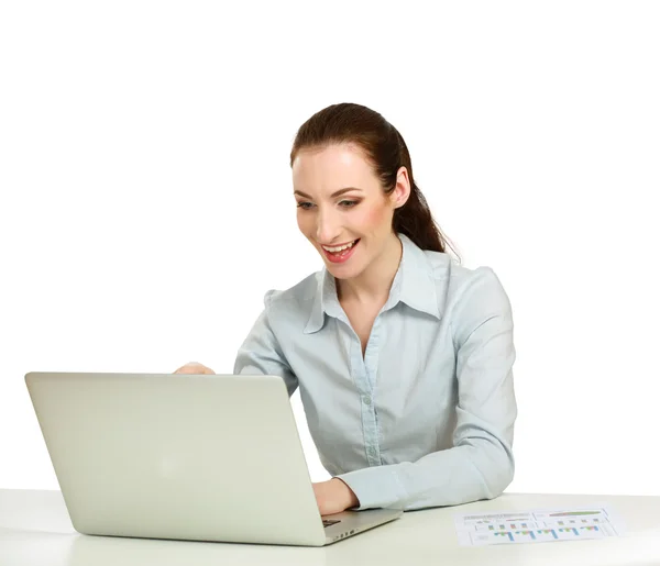 A young woman with a laptop sitting isolated on white background — Stock Photo, Image