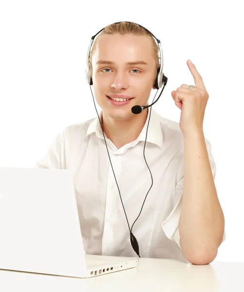 Young happy man with laptop sitting on the desk , isolated on white background — Stock Photo, Image