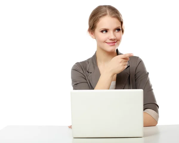 A young woman with a laptop sitting isolated on white background — Stock Photo, Image