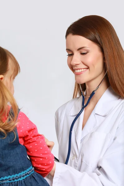 Little girl and young doctor in hospital having examination — Stock Photo, Image