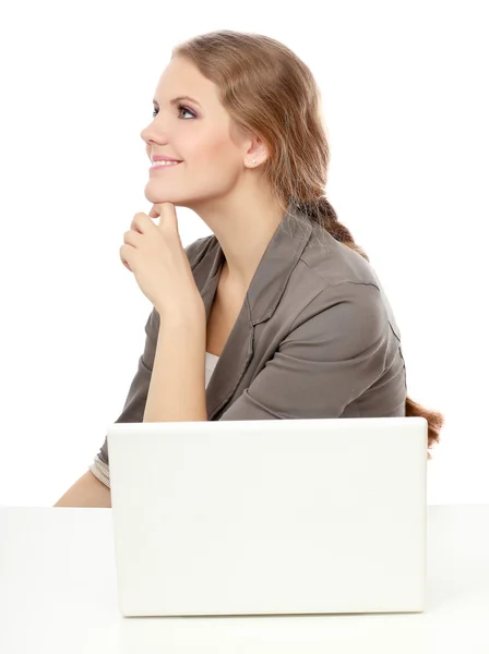 A young woman with a laptop sitting isolated on white background — Stock Photo, Image