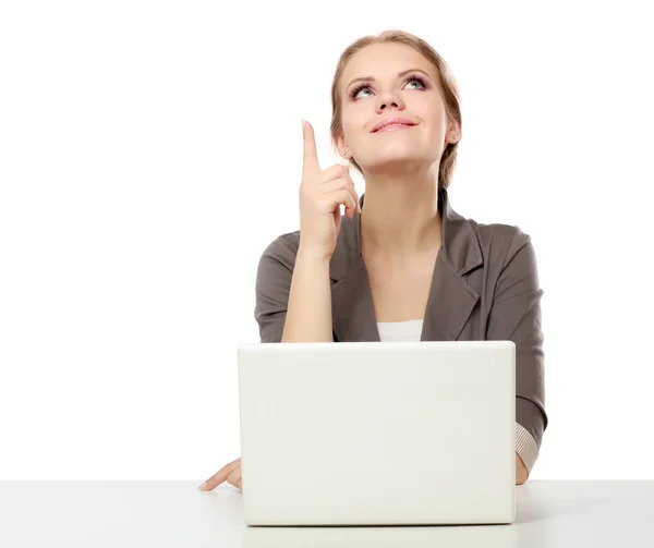 A young woman with a laptop sitting isolated on white background — Stock Photo, Image