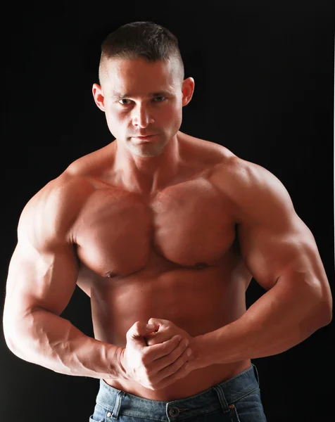Здоровий мускулистий молодий чоловік. Ізольовані на чорному тлі — стокове фото