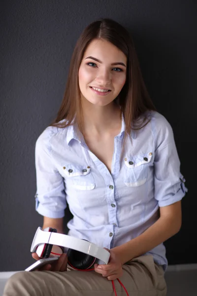 Smiling girl with headphones isolated on grey background — Stock Photo, Image