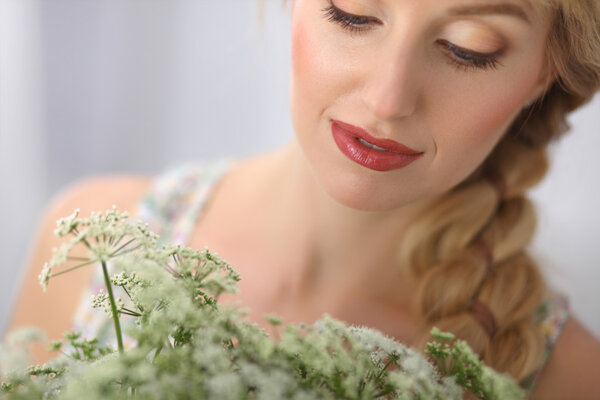 Young woman with beautiful hairstyle and flowers