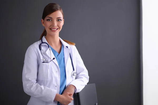 Piękne kobiece kobieta lekarz stojący w pobliżu stolca na białym tle szary backg — Zdjęcie stockowe