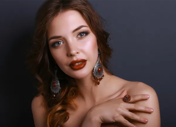 Portrait of young beautiful brunette woman in ear-rings — Stock Photo, Image