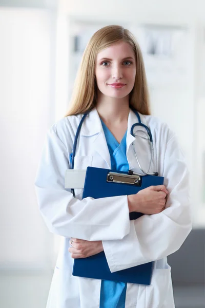 Portrait of woman doctor with folder at hospital corridor — Stock Photo, Image