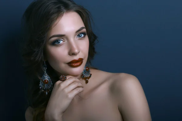 Portrait of young beautiful brunette woman in ear-rings — Stock Photo, Image