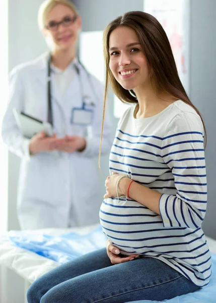 Beautiful smiling pregnant woman with the doctor at hospital — Stock Photo, Image