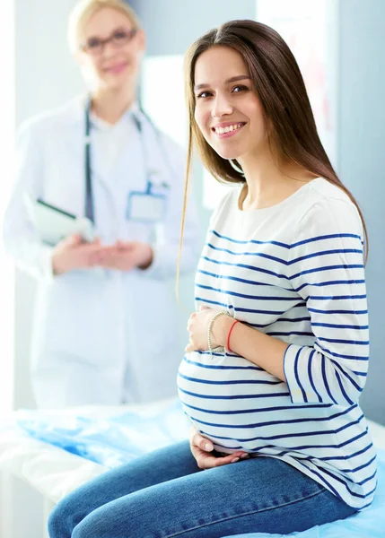 Hastanede doktorla gülümseyen güzel bir hamile kadın. — Stok fotoğraf
