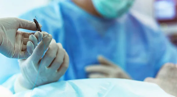 Man surgeon at work in operating room — Stock Photo, Image