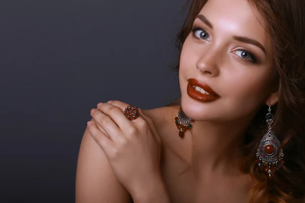 Portrait of young beautiful brunette woman in ear-rings — Stock Photo, Image