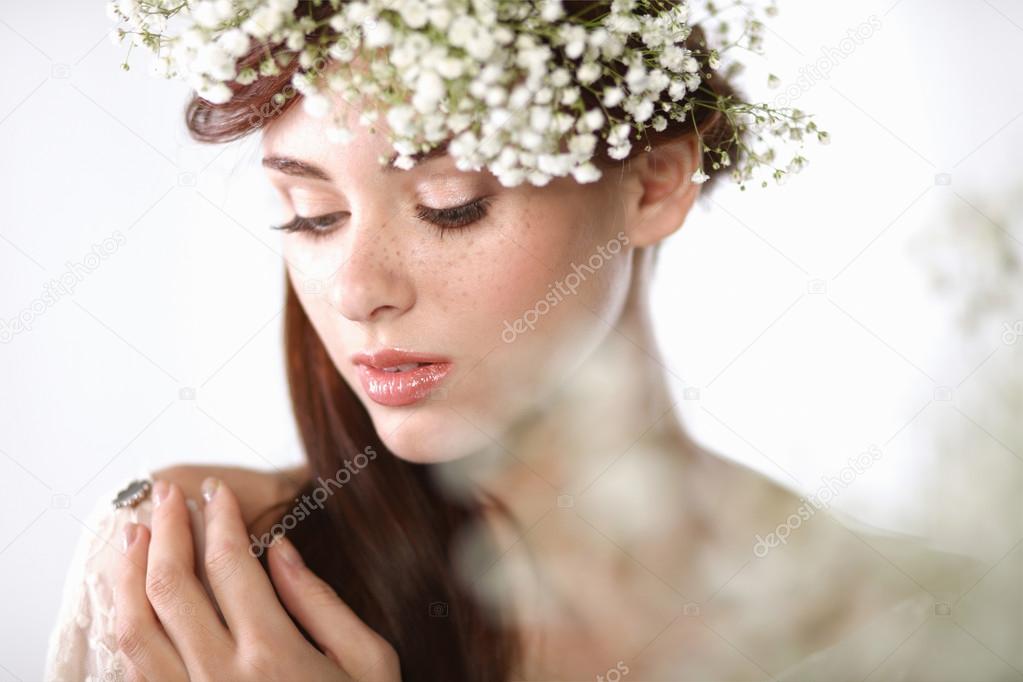 Portrait of a beautiful blonde woman with flowers in her hair