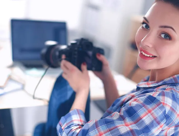 Kobieta fotograf siedzi na biurku z laptopem — Zdjęcie stockowe