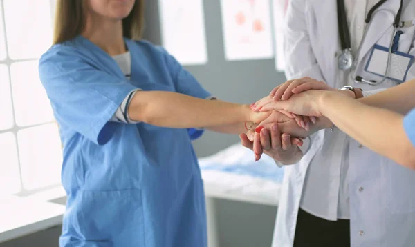 Doctors and nurses in a medical team stacking hands — Stock Photo, Image
