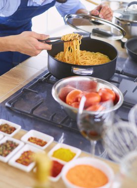 Adam ev mutfağında lezzetli ve sağlıklı yemekler hazırlıyor.