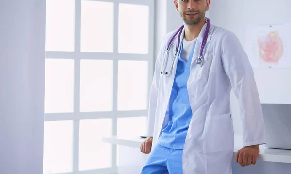 Young and confident male doctor portrait standing in medical office. — Stock Photo, Image