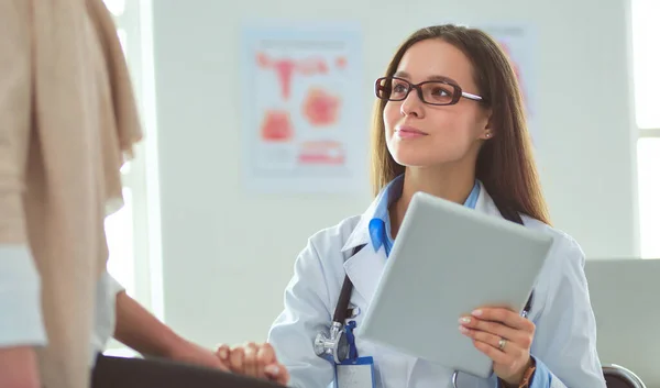 Dokter en patiënt bespreken iets terwijl ze aan tafel zitten. Begrip "geneeskunde en gezondheidszorg" — Stockfoto