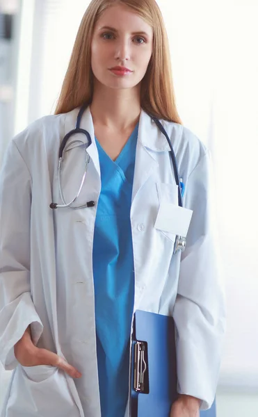 Retrato de médico mulher com pasta no corredor do hospital — Fotografia de Stock