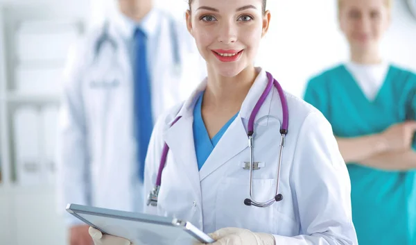 Woman doctor standing with folder at hospital Royalty Free Stock Images