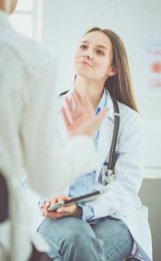 Doktor ve hasta masada otururken bir şey tartışıyorlar. İlaç ve sağlık hizmetleri kavramı