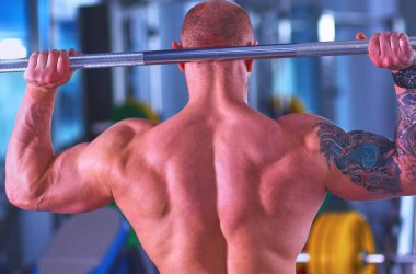 Halter salonunda ile ayakta vücut geliştirmeci .