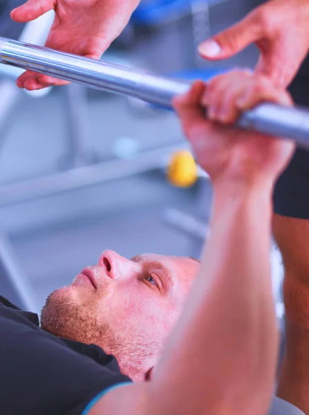 Junger Mann Hebt Mit Trainer Die Langhantel Der Turnhalle — Stockfoto