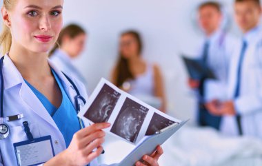 Doktor ve cerrah, muayenehanede röntgen analizi yapıyor. .