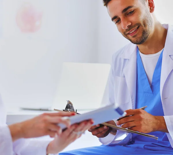 Handsome Doctor Talking Young Female Doctor Making Notes While Sitting — Stock Photo, Image
