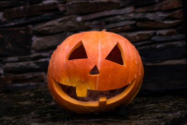 Traditional american Halloween Jack-o'-lantern, carved pumpkin with a scary grinning face 