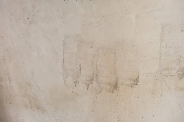 Old lime washed wall with paint roller stains, grunge background