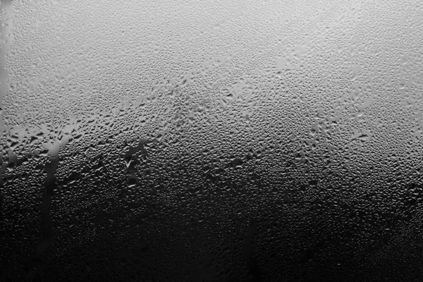 Rain droplets on a window glass, abstract background