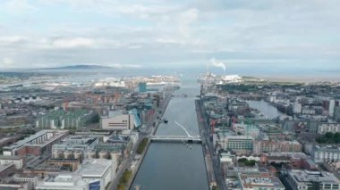 Kasabanın ve Liffey nehrinin deniz kenarındaki hava panoramik görüntüleri. Modern tasarım Samuel Beckett Köprüsü. Dublin, İrlanda