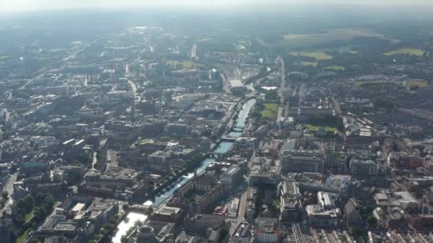 Aerial panoramic view of river flowing through city. View against sunshine, limited visibility. Dublin, Ireland — Stock Video
