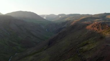 Güneşli bir günde, İzlanda 'nın dağlık bölgelerinde, Skoga nehrinin hava manzarası. Jeotermal gayzer sıcak su kraterleriyle muhteşem manzaraya insansız hava aracı bakış açısı